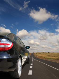 Black car on country road.